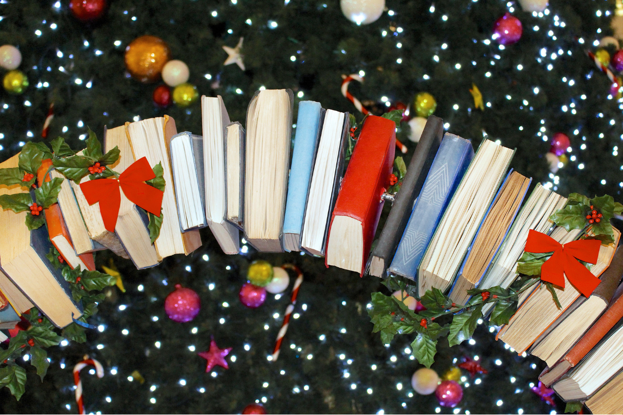 arc of books in front of Christmas tree