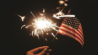 hand with flag and sparkler